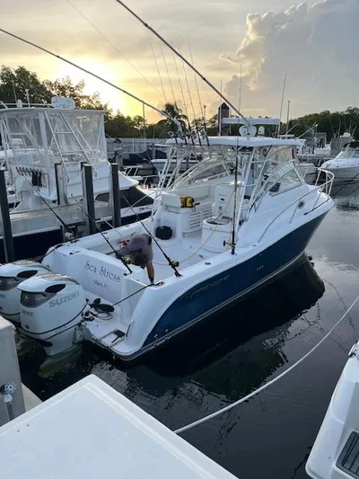 Sea Stress Yacht Photos Pics 2008 Pro-Line 32 Express boat docked at marina during sunset.