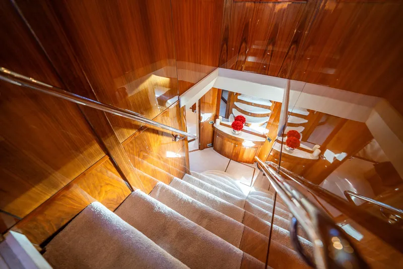 2010 Sunseeker Super Yacht Yacht Photos Pics Luxurious wooden staircase inside a 2010 Sunseeker 30m yacht, featuring elegant design elements.