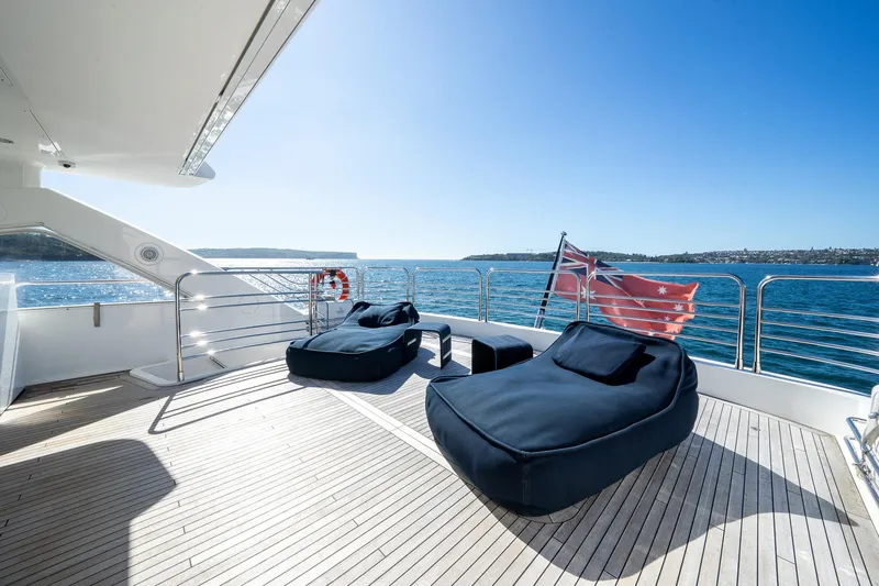 2010 Sunseeker Super Yacht Yacht Photos Pics Luxurious Sunseeker 30m yacht deck with bean bags, ocean view, and clear blue sky.