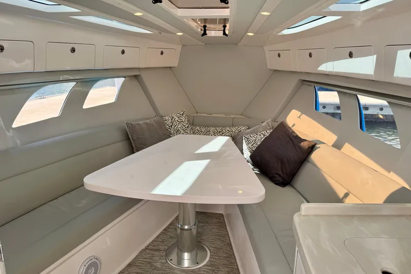  Yacht Photos Pics Luxurious interior of 2019 Intrepid 407 Cuddy boat with plush seating and elegant table.