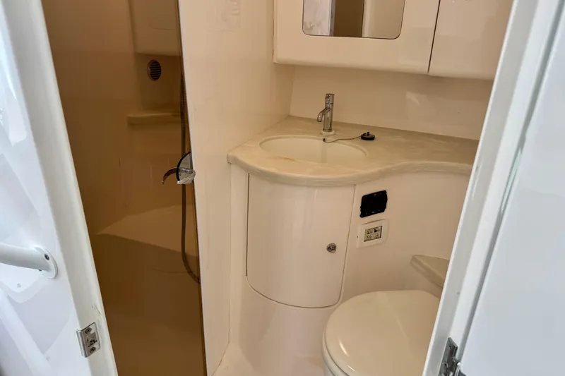  Yacht Photos Pics 2019 Intrepid 407 Cuddy bathroom with sink, toilet, and shower area.