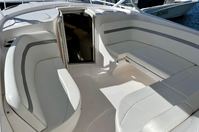  Yacht Photos Pics 2019 Intrepid 407 Cuddy boat interior with white seating and open cabin door.