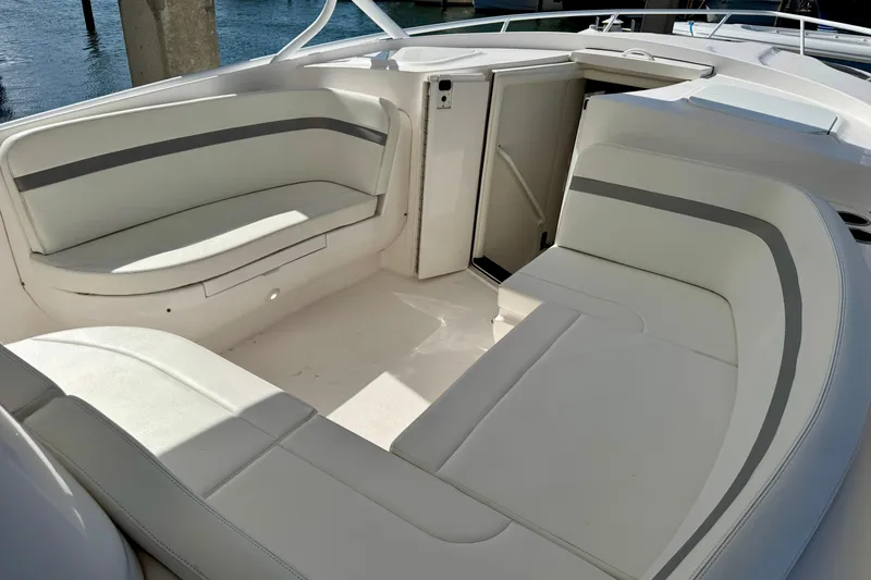  Yacht Photos Pics 2019 Intrepid 407 Cuddy boat interior with white cushioned seating.