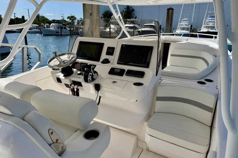  Yacht Photos Pics 2019 Intrepid 407 Cuddy boat interior with helm, seating, and navigation equipment.