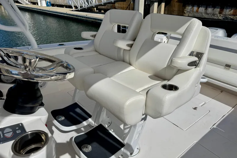  Yacht Photos Pics 2019 Intrepid 407 Cuddy helm with dual white seats and steering wheel.