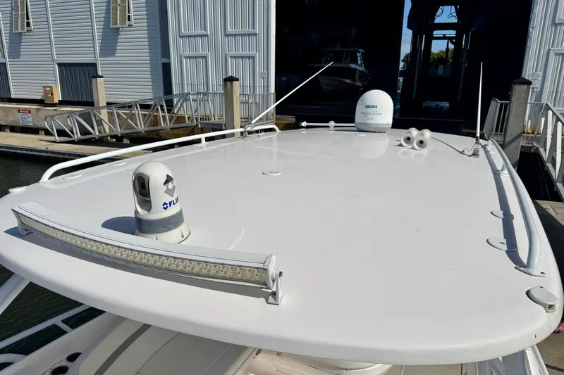  Yacht Photos Pics 2019 Intrepid 407 Cuddy boat roof with radar and antenna equipment at marina.