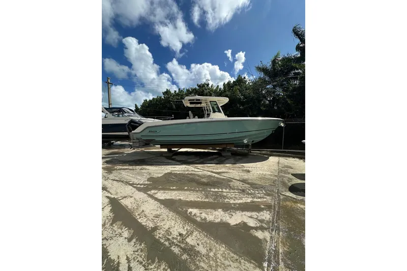  Yacht Photos Pics 2022 Boston Whaler 330 Outrage boat on display under a clear blue sky.