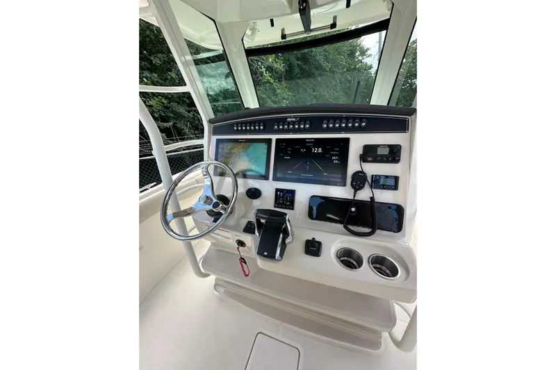  Yacht Photos Pics 2022 Boston Whaler 330 Outrage helm with advanced navigation and control systems.