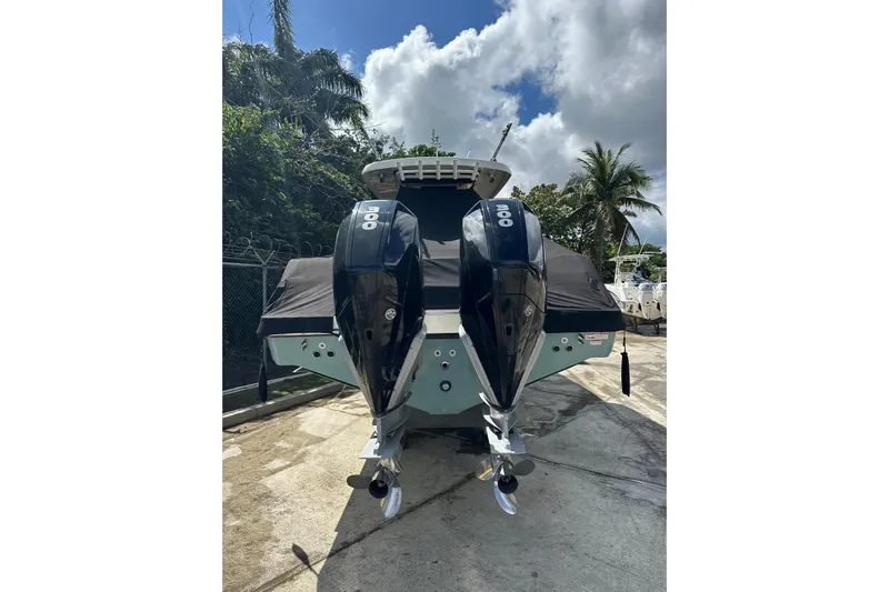  Yacht Photos Pics 2022 Boston Whaler 330 Outrage with dual outboard engines, docked outdoors.