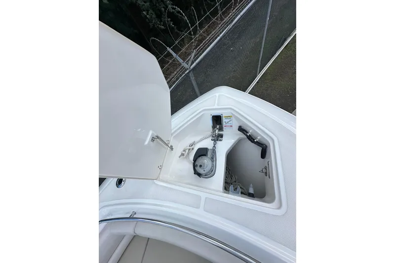  Yacht Photos Pics 2022 Boston Whaler 330 Outrage anchor compartment with open hatch and visible equipment.