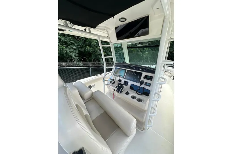  Yacht Photos Pics 2022 Boston Whaler 330 Outrage helm with modern controls and comfortable seating.