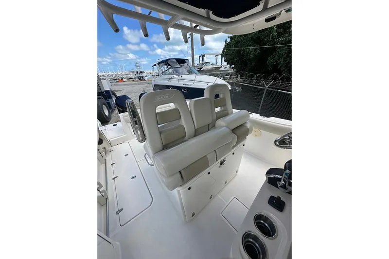  Yacht Photos Pics 2022 Boston Whaler 330 Outrage boat interior with seating and control panel.