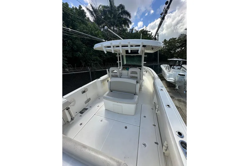  Yacht Photos Pics 2022 Boston Whaler 330 Outrage boat with spacious deck and seating, docked outdoors.
