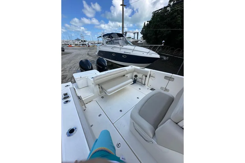  Yacht Photos Pics 2022 Boston Whaler 330 Outrage boat interior with seating and twin engines.