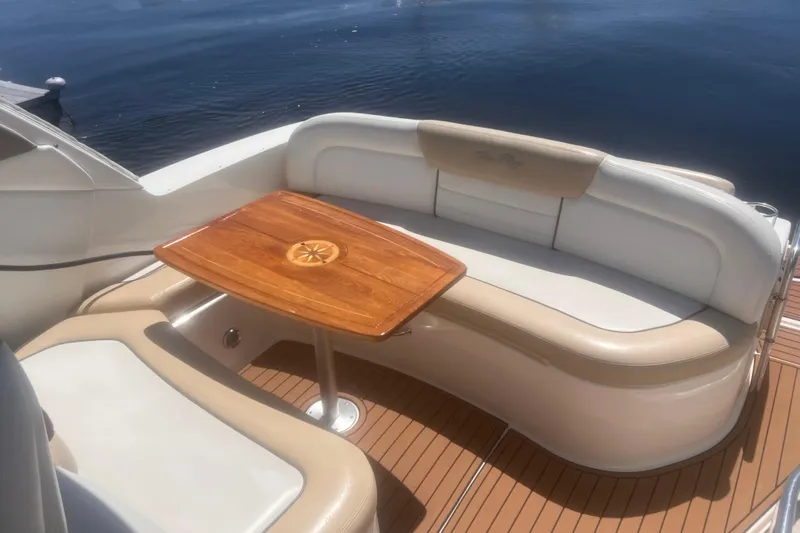 No Woke Zone Yacht Photos Pics 2008 Sea Ray 310 Sundancer boat with elegant seating and wooden table on deck.
