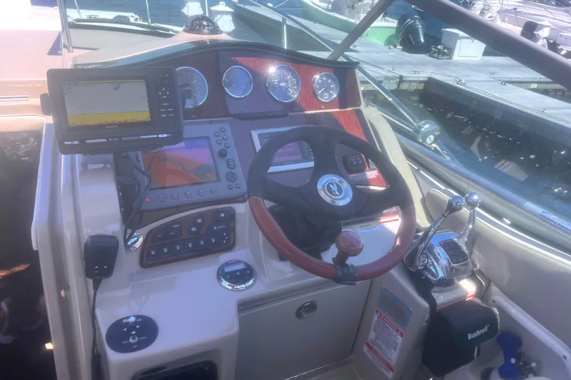No Woke Zone Yacht Photos Pics Cockpit of 2008 Sea Ray 310 Sundancer with navigation equipment and steering wheel.