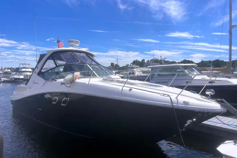 No Woke Zone Yacht Photos Pics 2008 Sea Ray 310 Sundancer yacht docked in a marina under a clear blue sky.