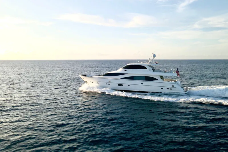 Tortuga Yacht Photos Pics Luxurious 2011 Horizon E88 yacht cruising on open sea at sunset.