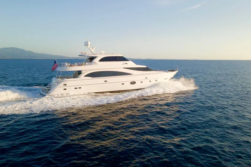 Tortuga Yacht Photos Pics Luxurious 2011 Horizon E88 yacht cruising on open sea at sunset.