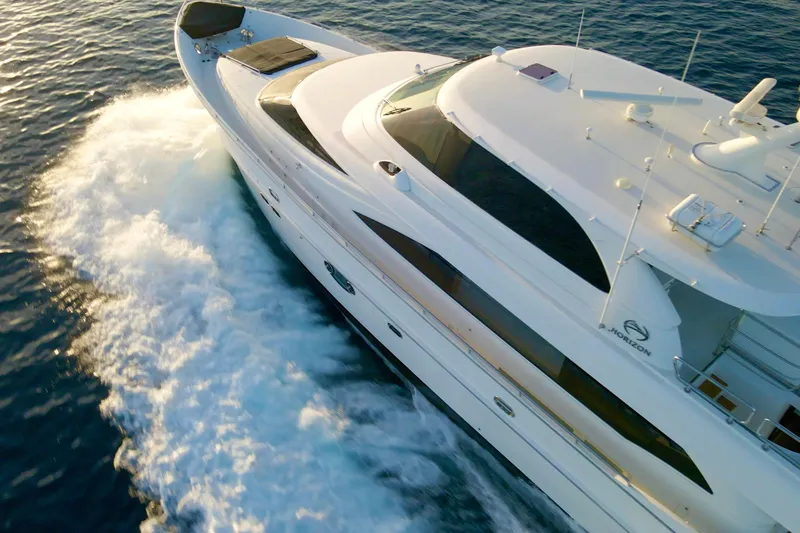 Tortuga Yacht Photos Pics Luxurious 2011 Horizon E88 yacht cruising on open water, aerial view.