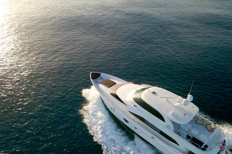 Tortuga Yacht Photos Pics Luxurious 2011 Horizon E88 yacht cruising on open sea at sunset.