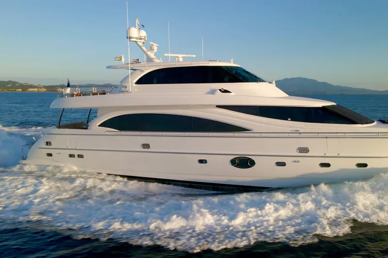 Tortuga Yacht Photos Pics Luxurious 2011 Horizon E88 yacht cruising on open sea at sunset.