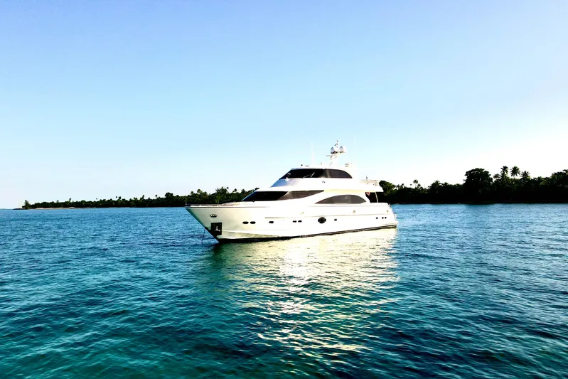 Tortuga Yacht Photos Pics Luxurious 2011 Horizon E88 yacht cruising on serene blue waters near a tropical island.