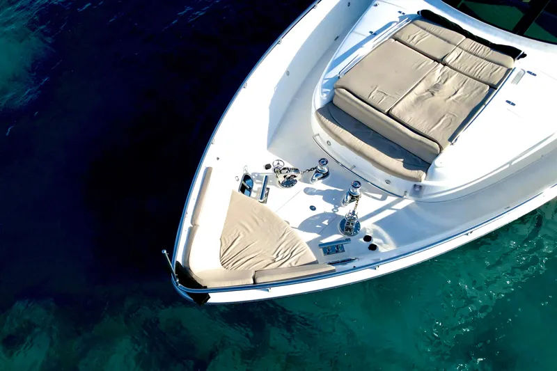 Tortuga Yacht Photos Pics Luxury Horizon E88 yacht bow with sunbathing area, 2011 model, on clear blue water.