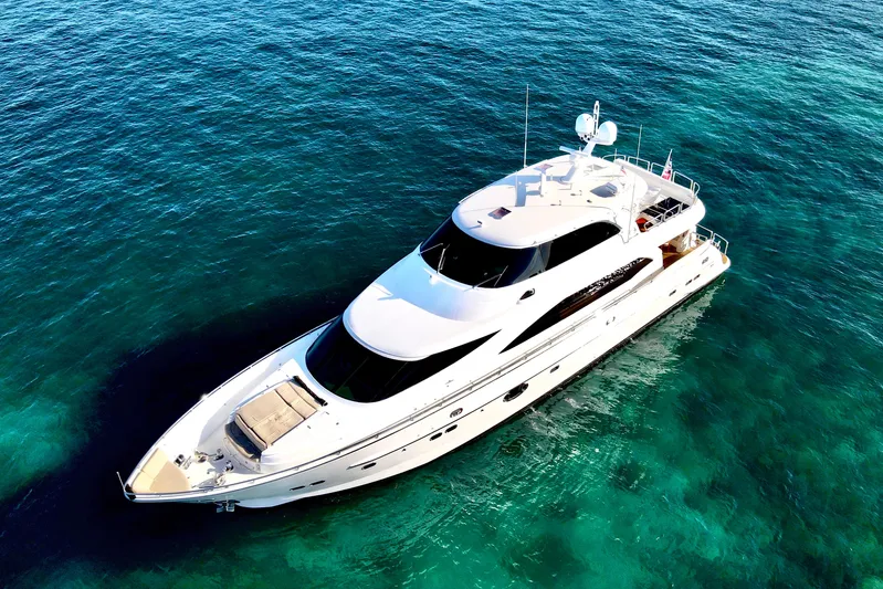 Tortuga Yacht Photos Pics Luxurious 2011 Horizon E88 yacht on clear turquoise waters, aerial view.