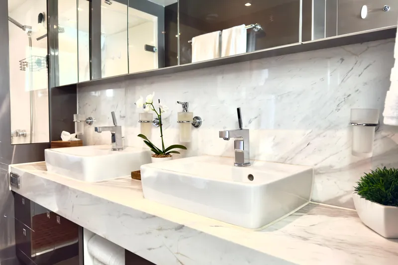 Tortuga Yacht Photos Pics Luxurious bathroom with dual sinks, marble countertop, and elegant decor on Horizon E88 yacht.