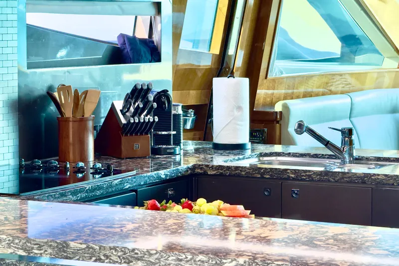 Tortuga Yacht Photos Pics Luxurious yacht kitchen interior with granite countertops, knife set, and modern appliances on Horizon E88, 2011.