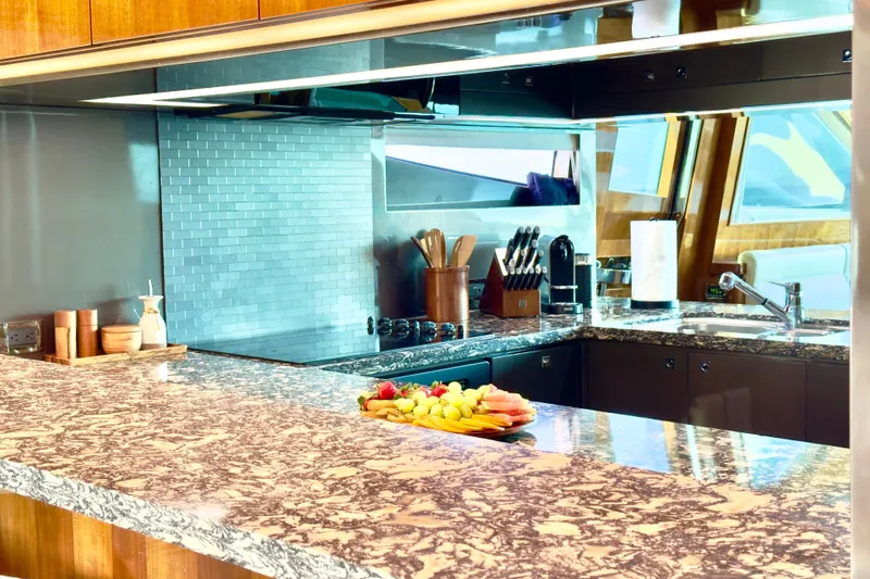 Tortuga Yacht Photos Pics Luxurious kitchen interior on 2011 Horizon E88 yacht with marble countertops and modern appliances.