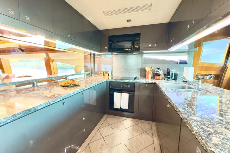 Tortuga Yacht Photos Pics Luxurious kitchen interior on 2011 Horizon E88 yacht with modern appliances and granite countertops.