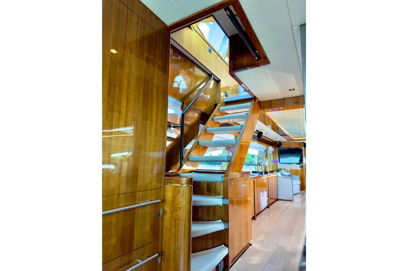 Tortuga Yacht Photos Pics Luxurious interior of 2011 Horizon E88 yacht with wooden staircase and modern design.