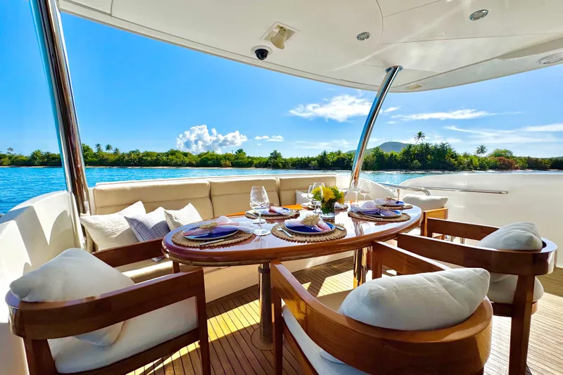 Tortuga Yacht Photos Pics Luxurious dining setup on Horizon E88 yacht, 2011 model, with scenic ocean view.
