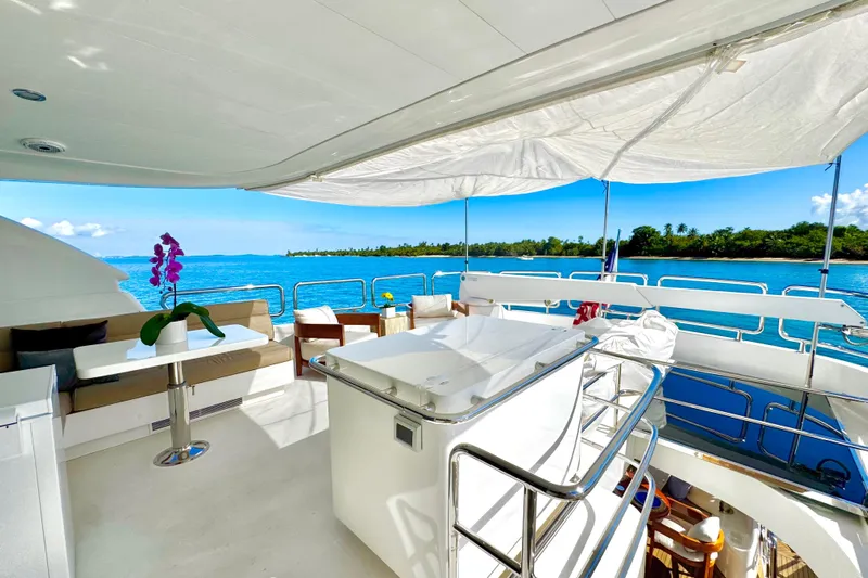 Tortuga Yacht Photos Pics Luxurious Horizon E88 yacht deck with ocean view, featuring seating and vibrant flowers, 2011 model.