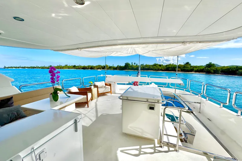 Tortuga Yacht Photos Pics Luxurious Horizon E88 yacht deck with seating, ocean view, and vibrant orchid, 2011 model.