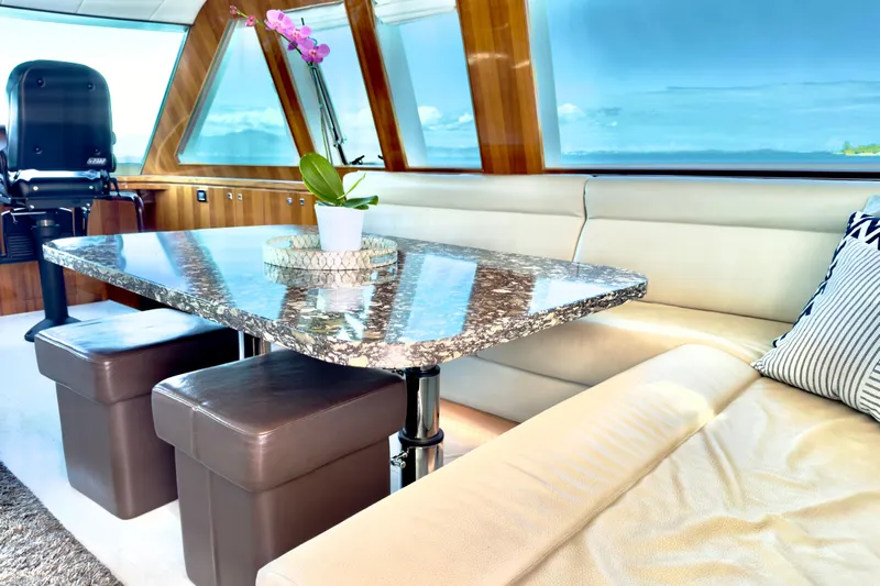 Tortuga Yacht Photos Pics Luxurious Horizon E88 yacht interior with marble table, leather seating, and ocean view.