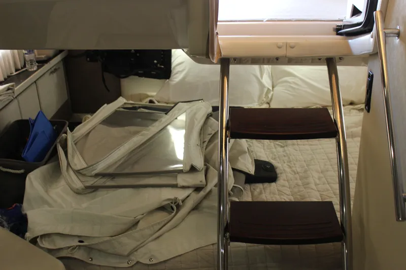  Yacht Photos Pics Interior cabin of 2014 Regal 32 Express boat with ladder and bedding.
