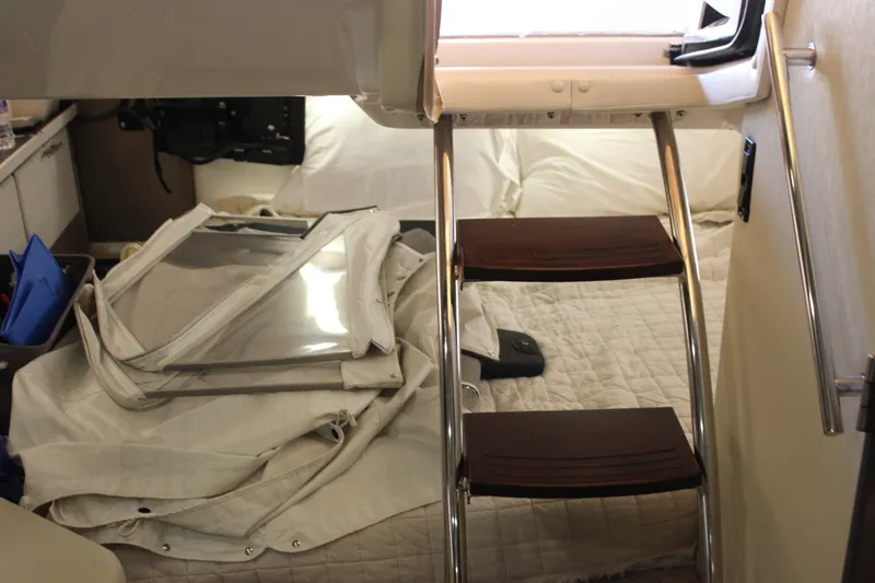  Yacht Photos Pics Interior cabin of 2014 Regal 32 Express boat with ladder and bedding.