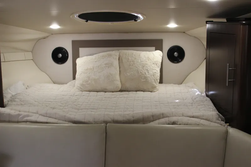  Yacht Photos Pics Cozy cabin interior of 2014 Regal 32 Express with plush bedding and ambient lighting.