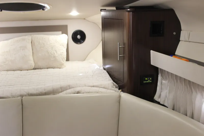  Yacht Photos Pics Interior cabin of 2014 Regal 32 Express boat with bed and storage.