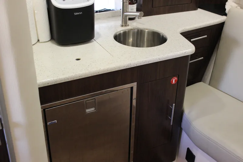  Yacht Photos Pics 2014 Regal 32 Express yacht interior with kitchenette, sink, and storage cabinets.