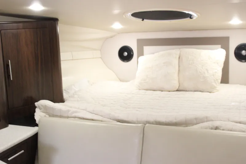  Yacht Photos Pics 2014 Regal 32 Express cabin interior with cozy bed and wooden cabinetry.