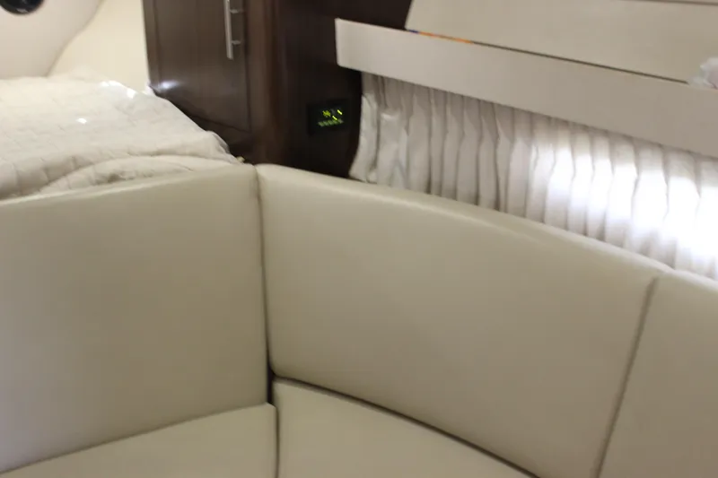  Yacht Photos Pics Interior of 2014 Regal 32 Express yacht with beige seating and elegant wood paneling.