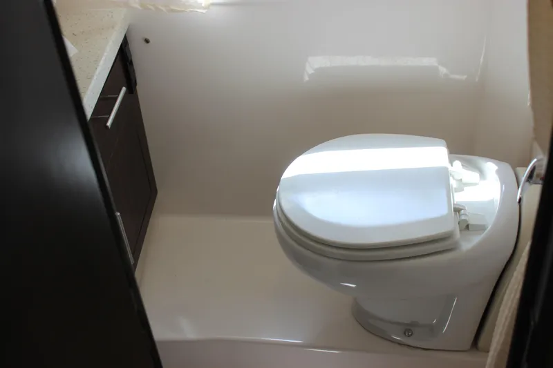  Yacht Photos Pics 2014 Regal 32 Express boat bathroom with modern toilet and dark cabinetry.
