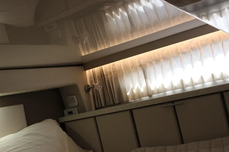  Yacht Photos Pics Interior cabin of 2014 Regal 32 Express yacht with soft lighting and curtains.