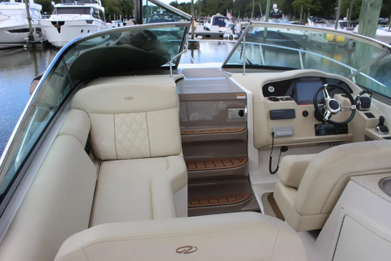  Yacht Photos Pics 2014 Regal 32 Express boat interior with beige seating and modern dashboard at marina.
