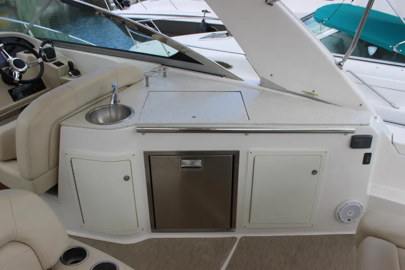  Yacht Photos Pics 2014 Regal 32 Express boat interior with sink, countertop, and storage cabinets.