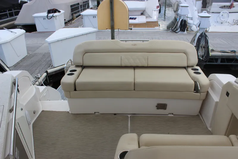  Yacht Photos Pics 2014 Regal 32 Express boat interior with beige seating and cup holders at dock.